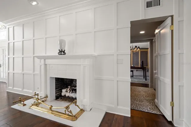 a view of a living room and kitchen with furniture wooden floor and a fireplace