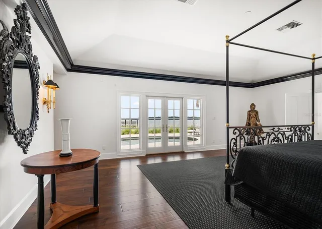 a patio with table and chairs and potted plants