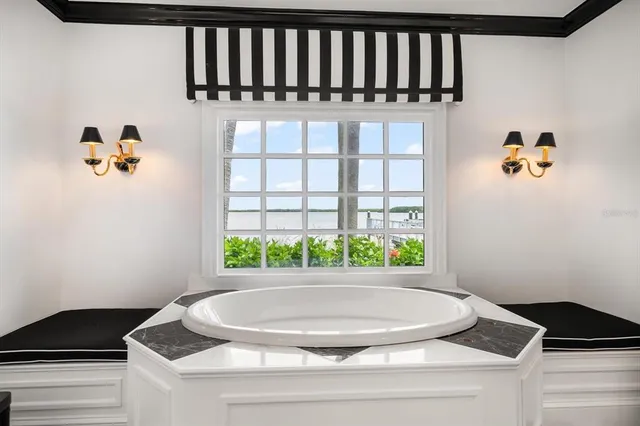 a view of a house with a yard and palm trees