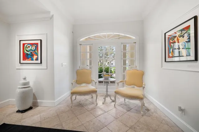 a view of a patio with table and chairs and potted plants