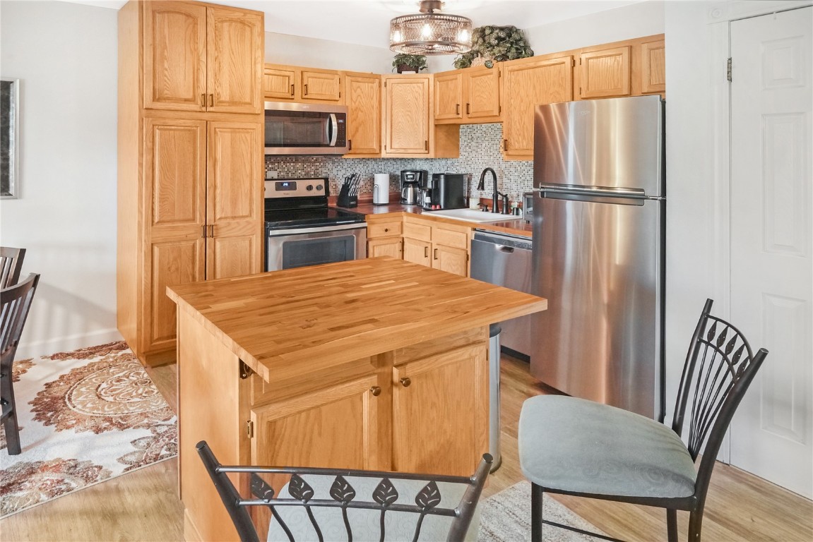 150 Evergreen Road, Unit C303 Dillon, CO 80435 - Photo 11 of 35 a kitchen with stainless steel appliances a refrigerator stove microwave and table