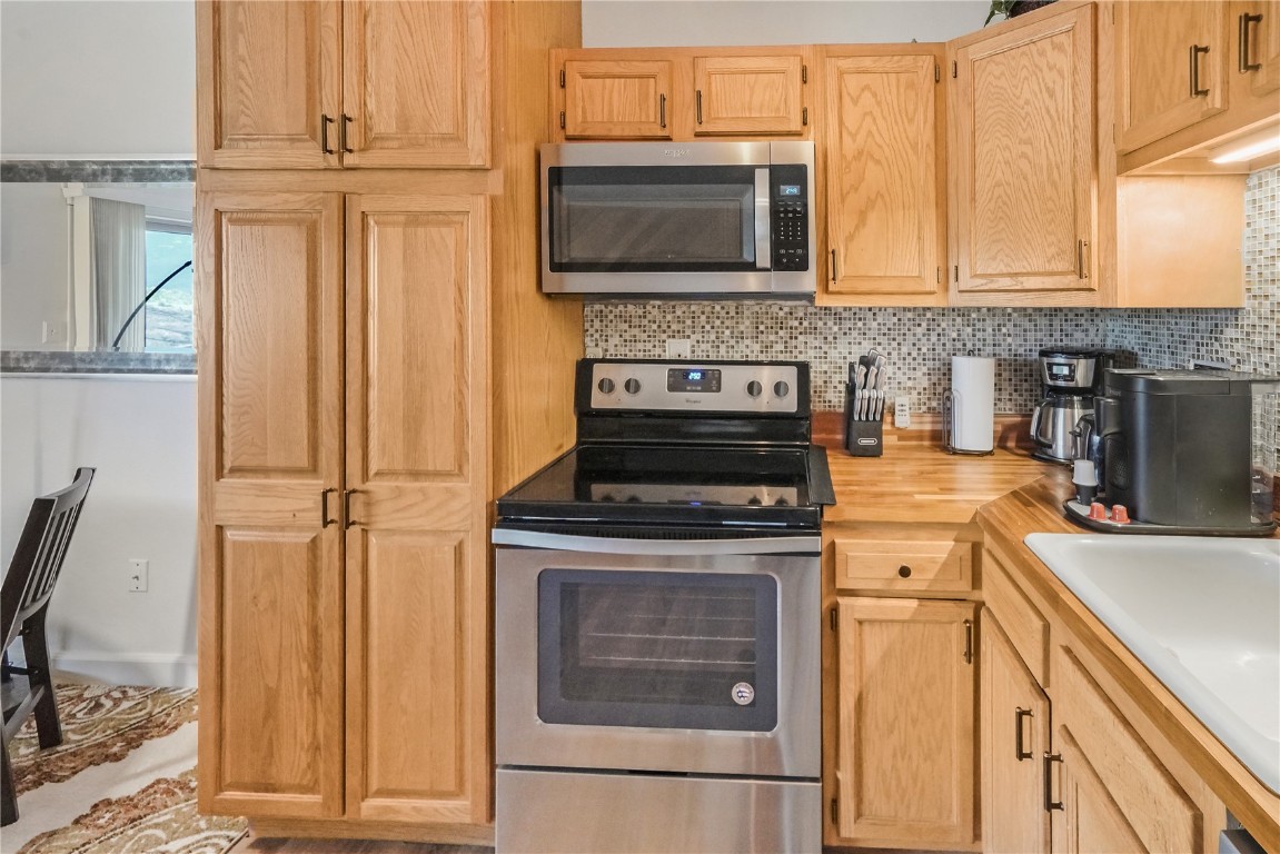 150 Evergreen Road, Unit C303 Dillon, CO 80435 - Photo 13 of 35 a kitchen with granite countertop a stove top oven microwave and cabinets