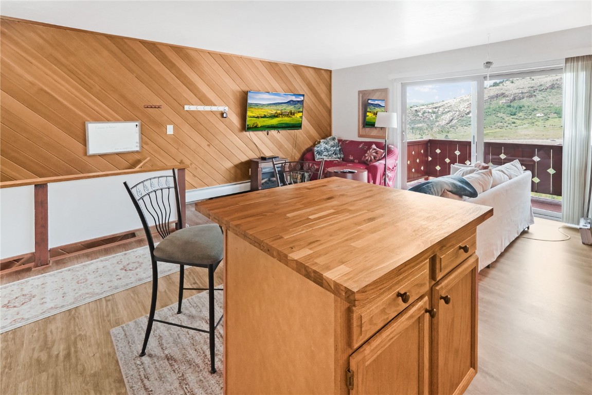 150 Evergreen Road, Unit C303 Dillon, CO 80435 - Photo 14 of 35 a view of a dining room with furniture a chandelier and wooden floor