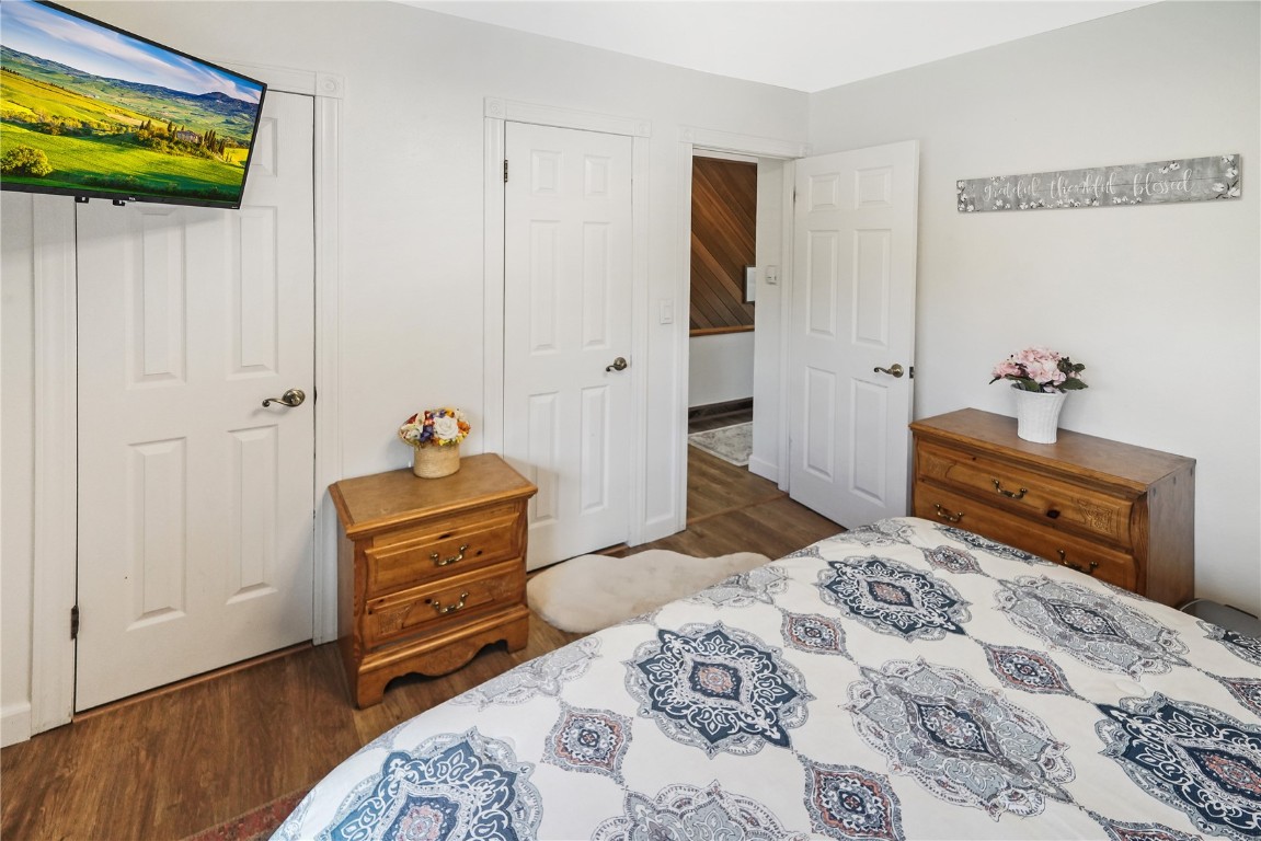 150 Evergreen Road, Unit C303 Dillon, CO 80435 - Photo 26 of 35 a bedroom with a bed and wooden floor