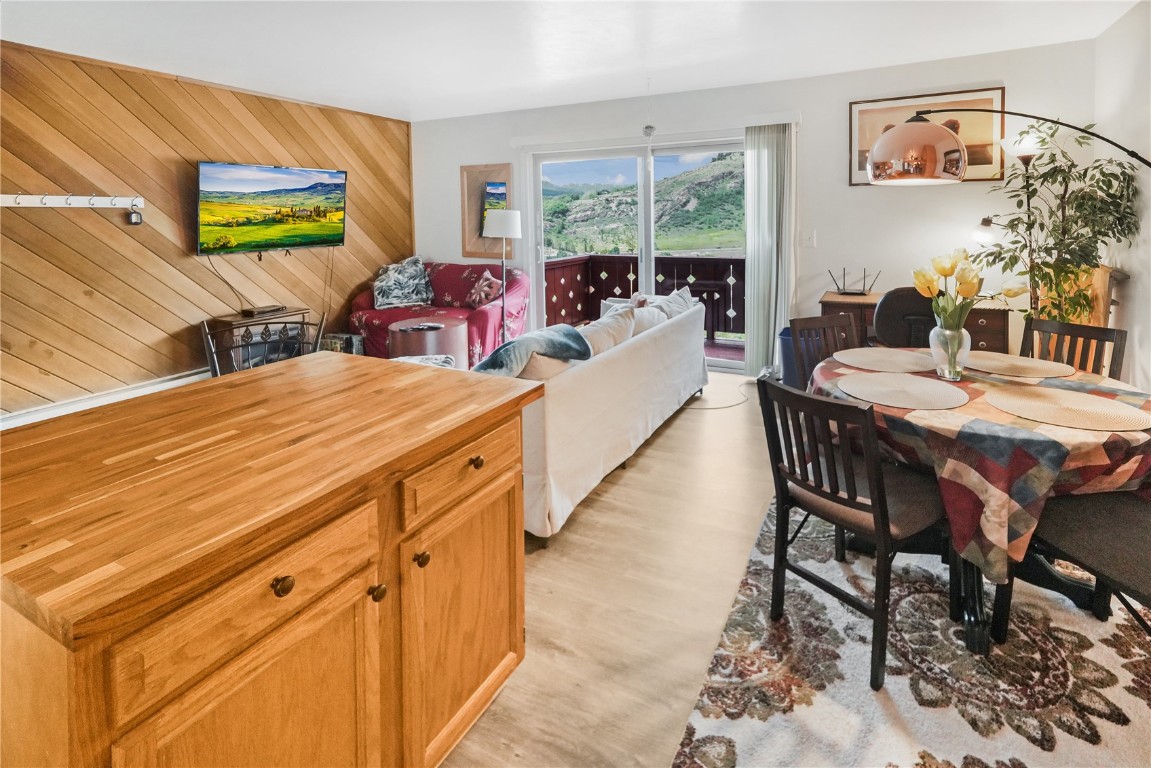 150 Evergreen Road, Unit C303 Dillon, CO 80435 - Photo 4 of 35 a dining room with furniture and a painting on the wall