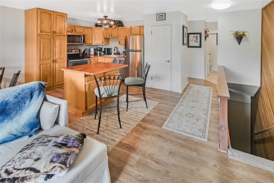 150 Evergreen Road, Unit C303 Dillon, CO 80435 - Photo 7 of 35 a living room with dining room and wooden floor