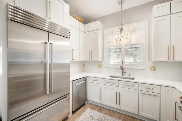 a kitchen with a sink window and cabinets