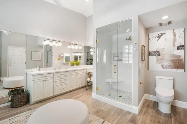 a bathroom with a toilet a sink and shower