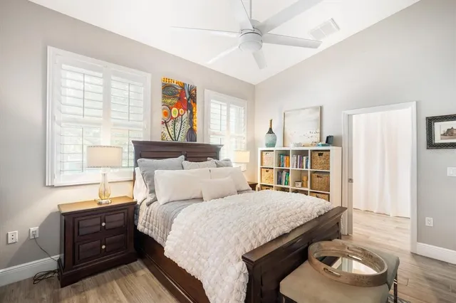 a bedroom with a bed and wooden floor