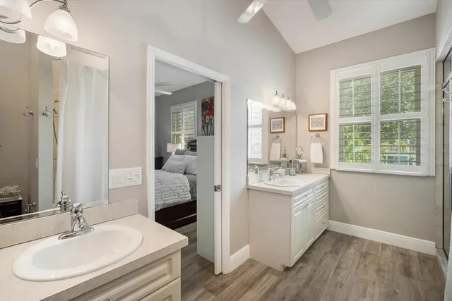 a en suite bathroom with a double vanity sink a mirror and a shower