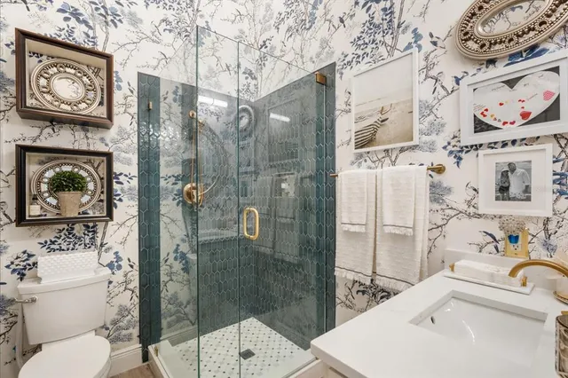 a bathroom with a sink toilet and shower