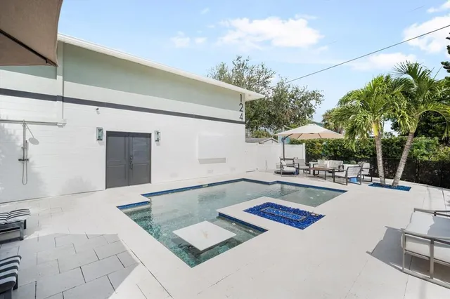 a view of a backyard with sitting area