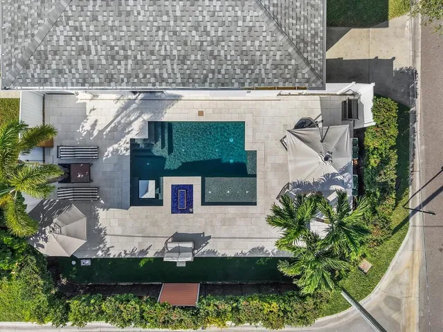 an aerial view of a house with a yard