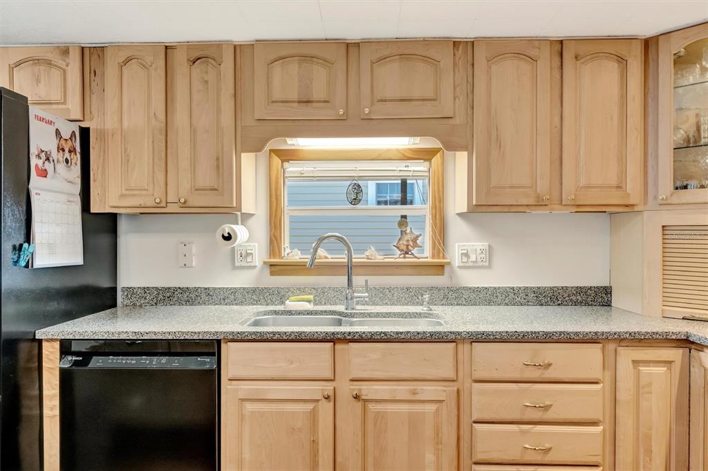 132 West St Lucia Loop Apollo Beach, FL 33572 - Photo 13 of 57 a kitchen with granite countertop white cabinets and sink