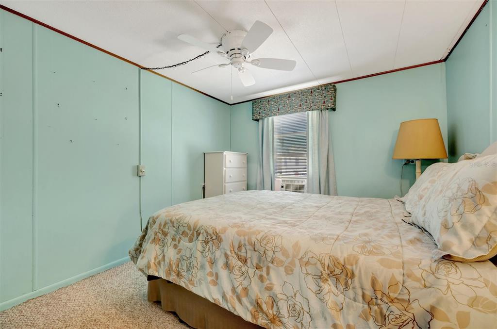 132 West St Lucia Loop Apollo Beach, FL 33572 - Photo 24 of 57 a bedroom with a bed and a chandelier