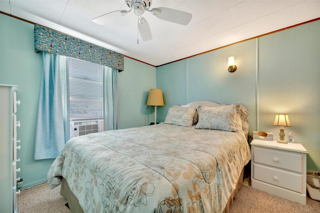 132 West St Lucia Loop Apollo Beach, FL 33572 - Photo 25 of 57 a bedroom with a bed and a chandelier