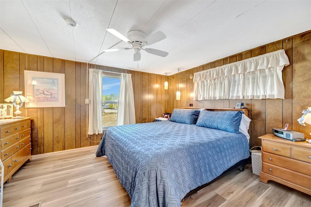 132 West St Lucia Loop Apollo Beach, FL 33572 - Photo 31 of 57 a bedroom with a bed and wooden floor