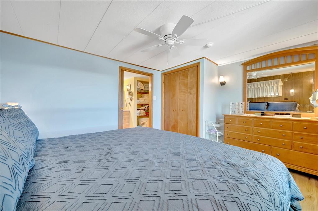 132 West St Lucia Loop Apollo Beach, FL 33572 - Photo 34 of 57 a bedroom with a large bed cabinet and a window