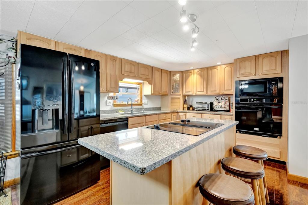 132 West St Lucia Loop Apollo Beach, FL 33572 - Photo 4 of 57 a kitchen with stainless steel appliances granite countertop a sink a stove and a refrigerator
