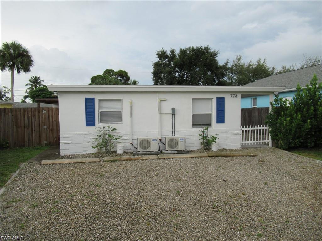 front view of house with potted plants
