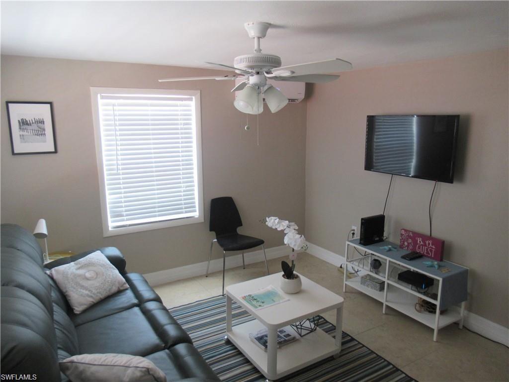 778 107th Avenue North, Unit B Naples, FL 34108 - Photo 3 of 10 a living room with furniture and a flat screen tv