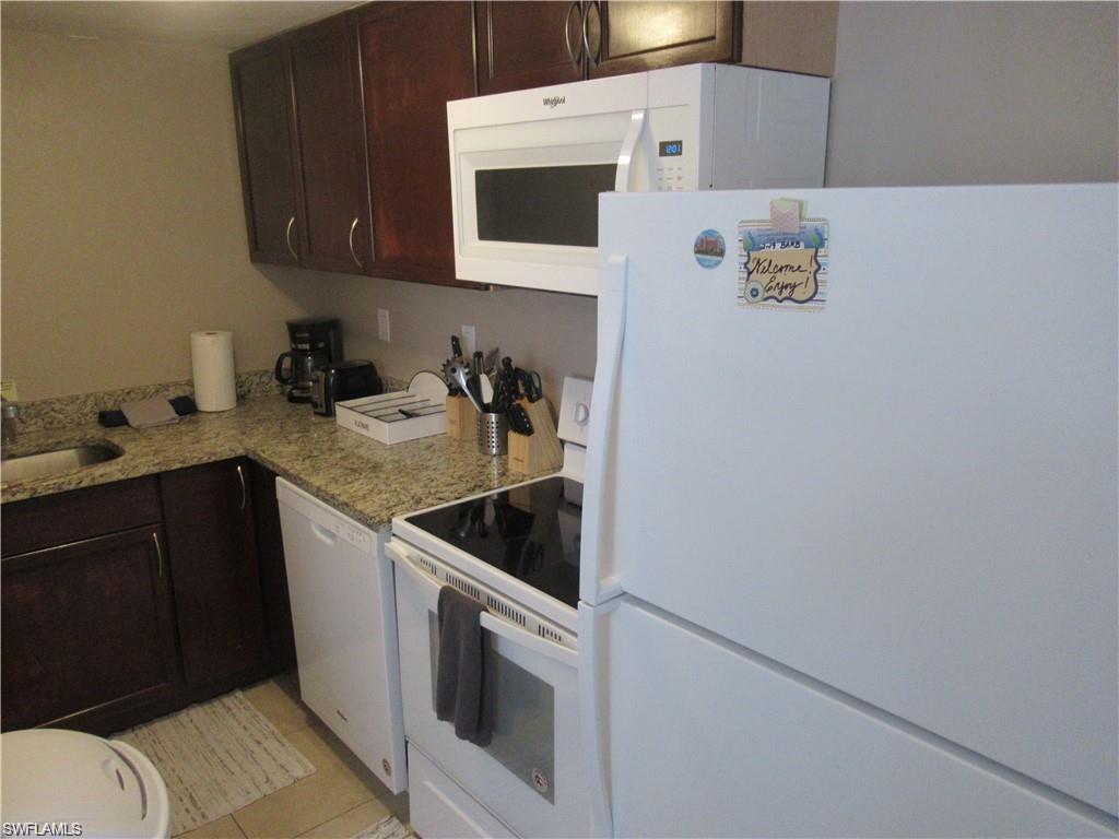 778 107th Avenue North, Unit B Naples, FL 34108 - Photo 7 of 10 a kitchen with a sink and a stove top oven