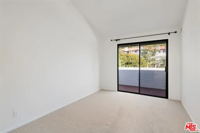 a view of empty room with wooden floor and fireplace