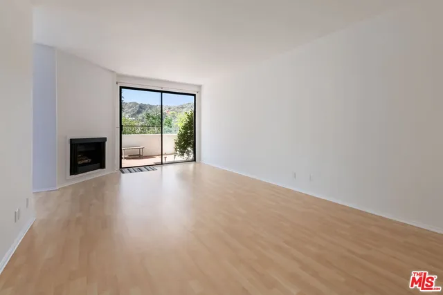 a view of an empty room with fire place and a fireplace
