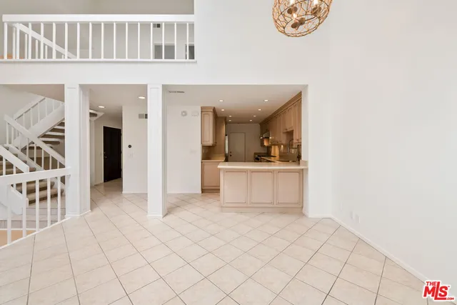 a open white kitchen with cabinets and a sink