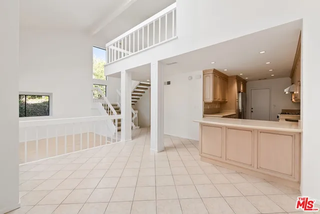 a kitchen with stainless steel appliances a sink a stove a refrigerator cabinets and a counter top space