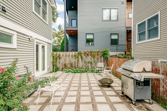 a view of a chairs and table in backyard