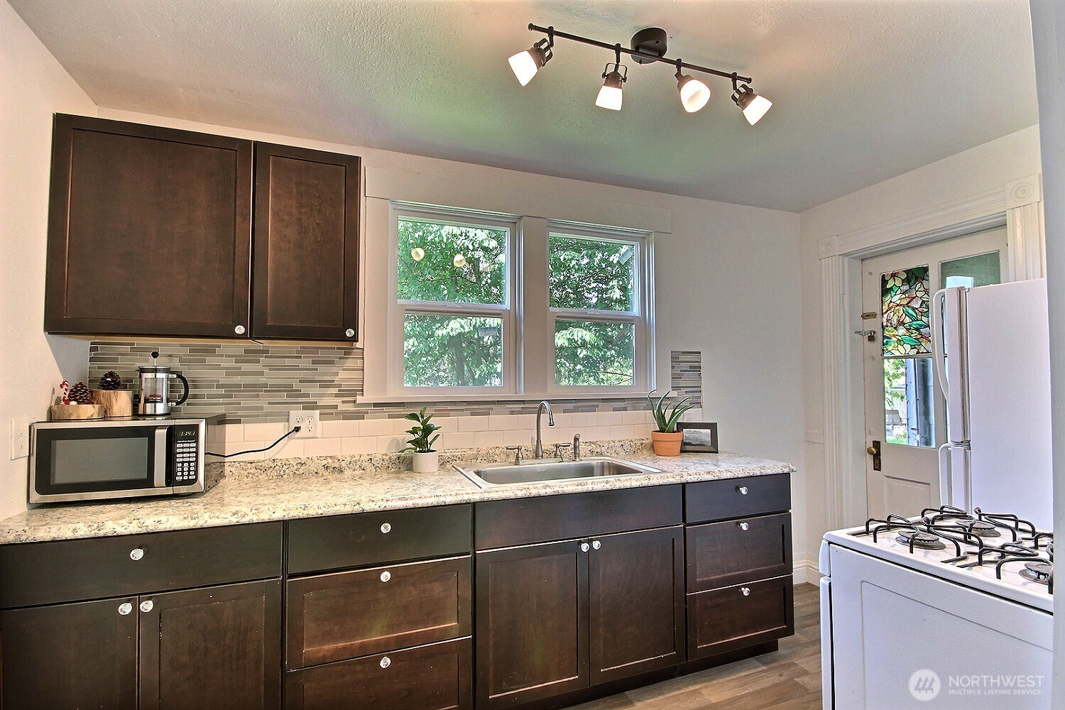 414 Sumner Avenue Sumner, WA 98390 - Photo 11 of 22 a kitchen with sink a window and appliances