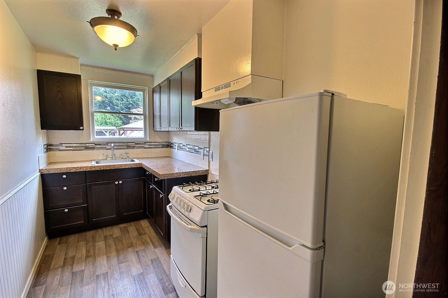 414 Sumner Avenue Sumner, WA 98390 - Photo 3 of 22 a kitchen with a refrigerator and a sink