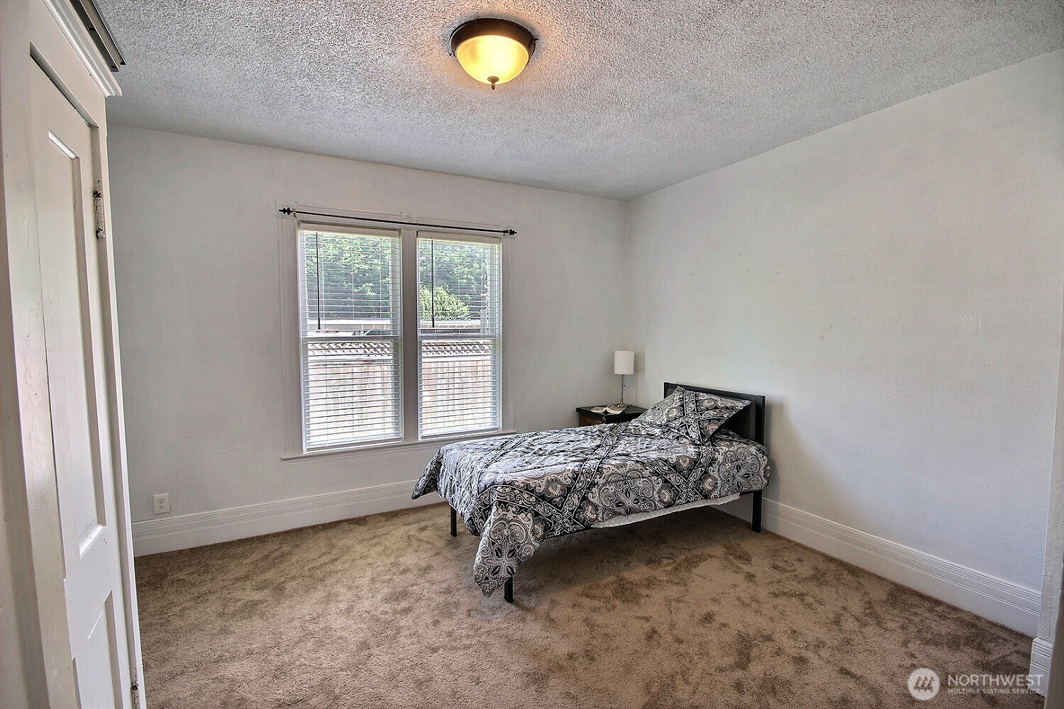 414 Sumner Avenue Sumner, WA 98390 - Photo 8 of 22 a bedroom with a bed and a window