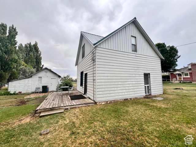 350 West Main Street Emery, UT 84522 - Photo 21 of 28 View of side of home with a yard, board and batten siding, a wooden deck, and a metal roof