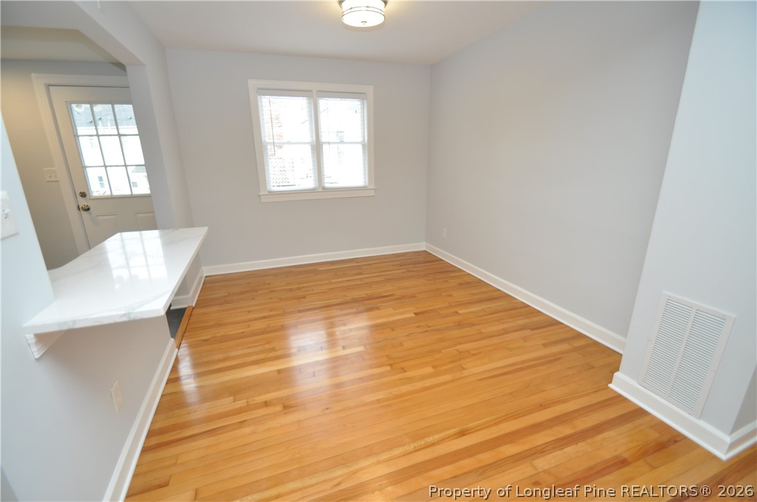1008 Nichols Drive Raleigh, NC 27605 - Photo 12 of 33 a view of an empty room with wooden floor and a window