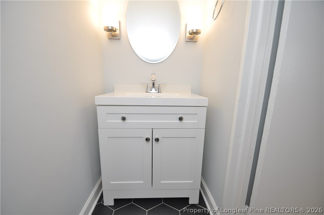 1008 Nichols Drive Raleigh, NC 27605 - Photo 22 of 33 a bathroom with a sink and a mirror