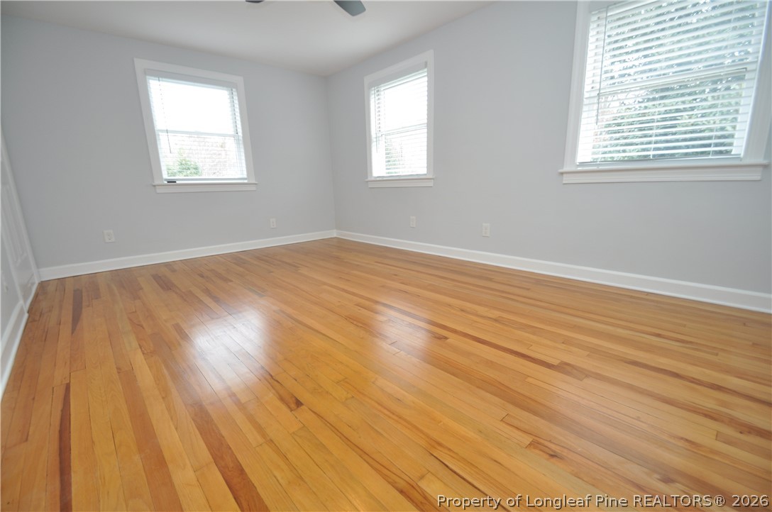 1008 Nichols Drive Raleigh, NC 27605 - Photo 24 of 33 an empty room with wooden floor and windows