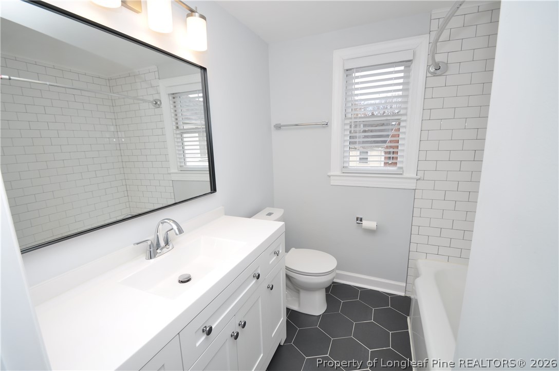 1008 Nichols Drive Raleigh, NC 27605 - Photo 30 of 33 a bathroom with a sink and a mirror