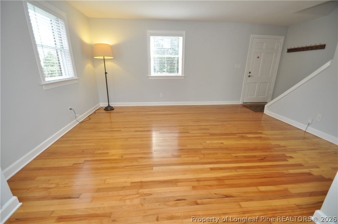 1008 Nichols Drive Raleigh, NC 27605 - Photo 3 of 33 a view of an empty room with wooden floor and a window