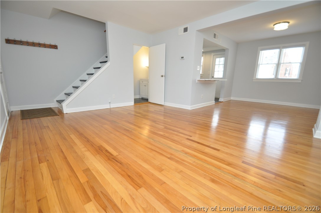 1008 Nichols Drive Raleigh, NC 27605 - Photo 5 of 33 an empty room with wooden floor and windows