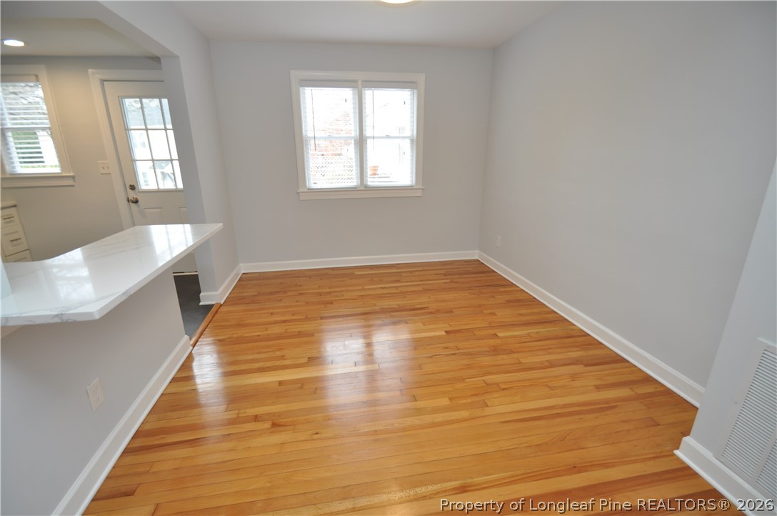 1008 Nichols Drive Raleigh, NC 27605 - Photo 8 of 33 a view of an empty room with wooden floor and a window