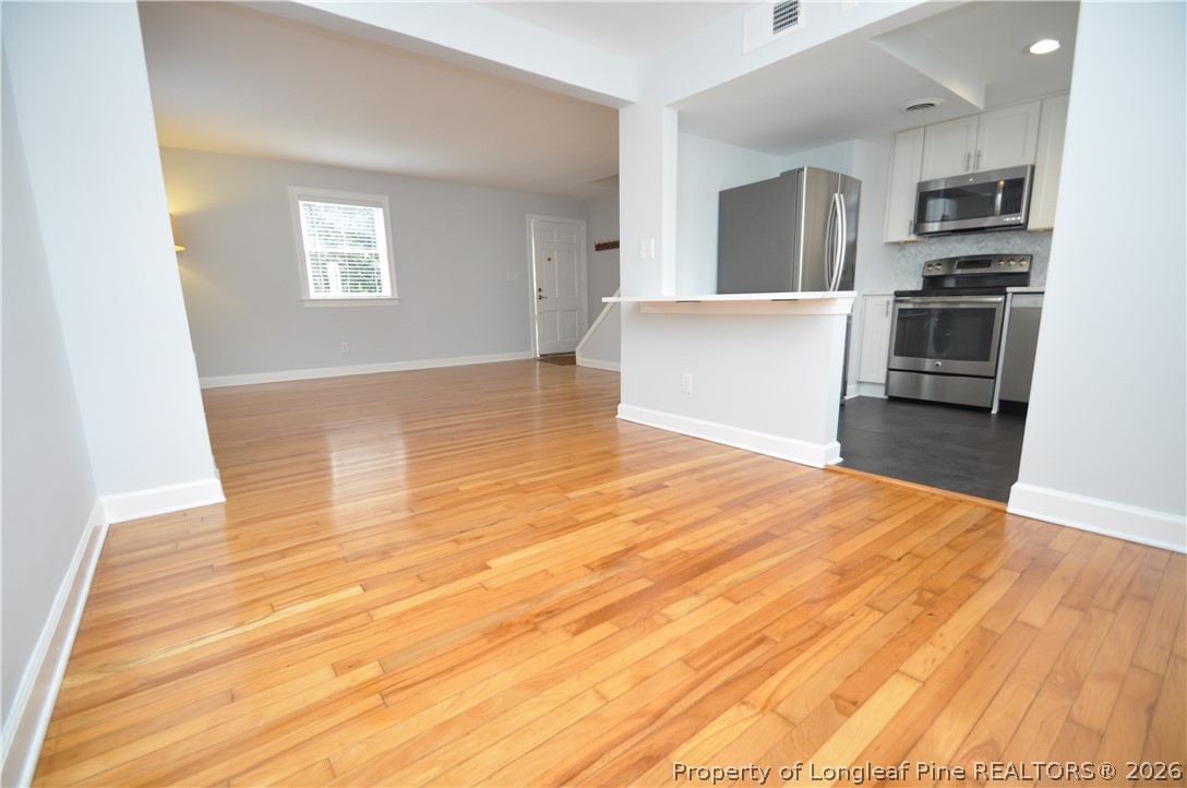 1008 Nichols Drive Raleigh, NC 27605 - Photo 9 of 33 a view of a kitchen with wooden floor and electronic appliances