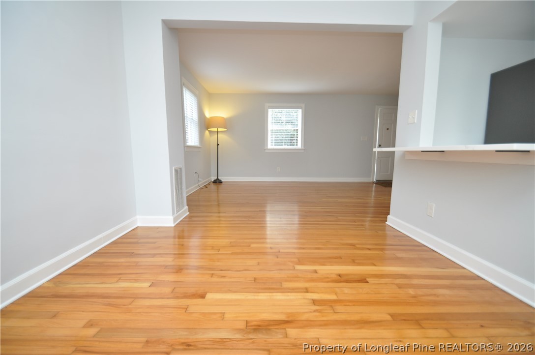 1008 Nichols Drive Raleigh, NC 27605 - Photo 10 of 33 a view of an empty room with wooden floor and a window