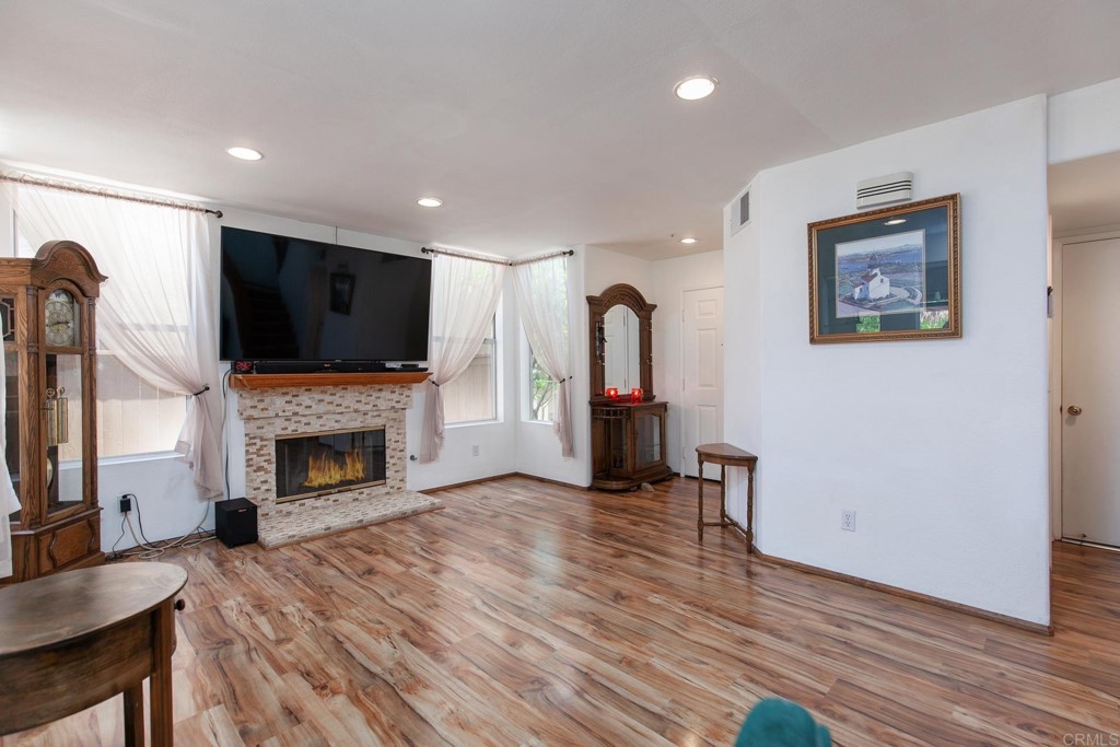305 Cobblestone Place Santee, CA 92071 - Photo 2 of 36 a living room with furniture a fireplace and a flat screen tv