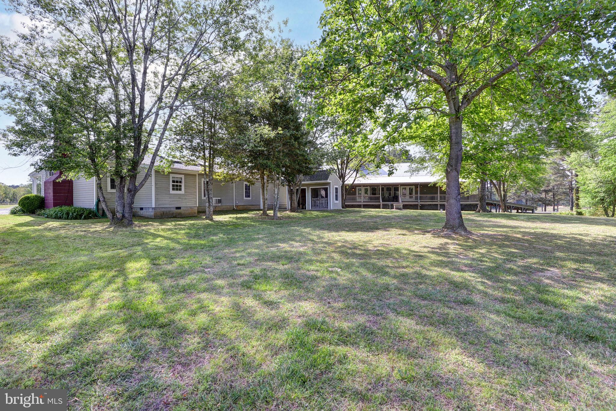 1025 Goodluck Road Lancaster, VA 22503 - Photo 114 of 132 a view of a house with a big yard and large trees