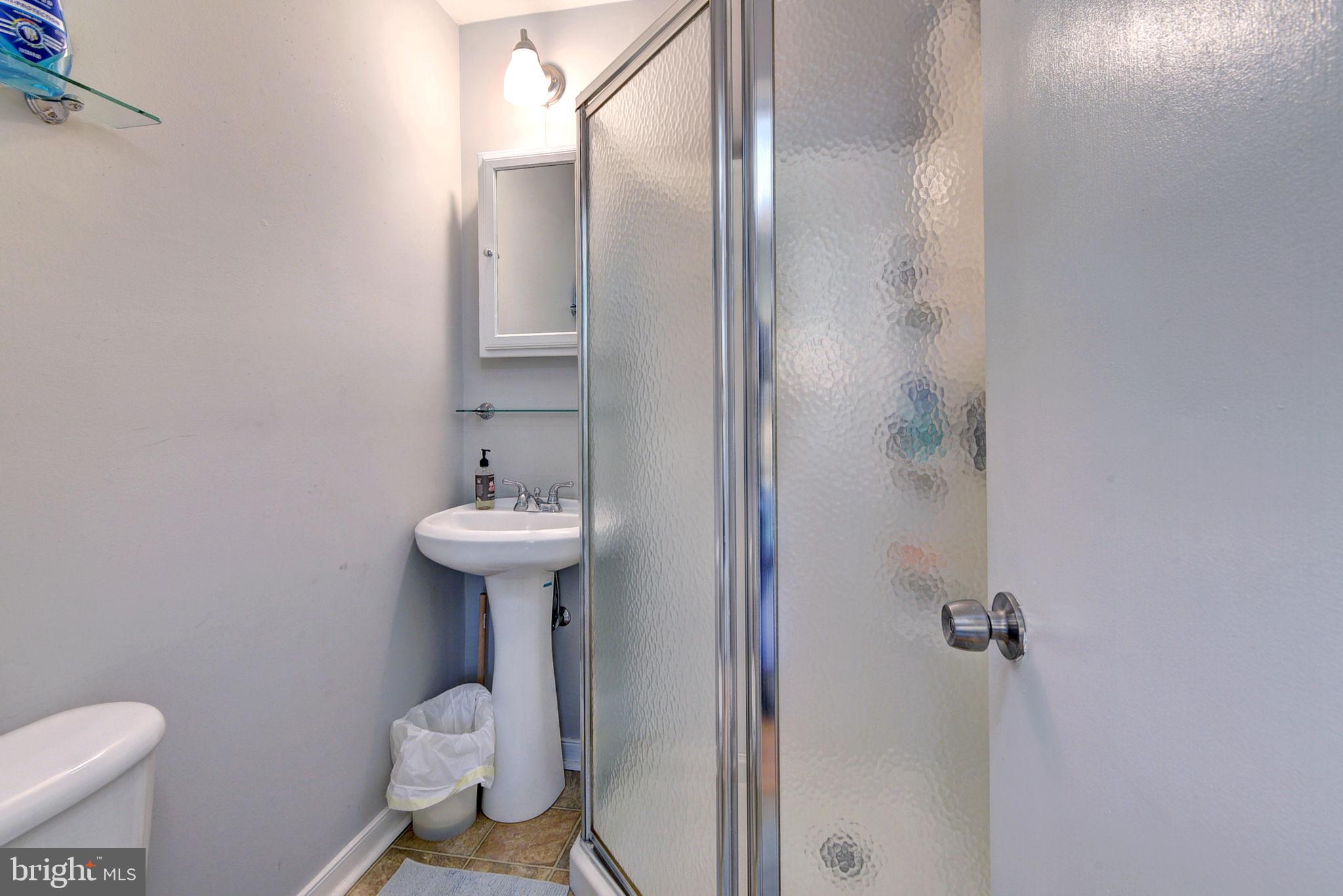 1025 Goodluck Road Lancaster, VA 22503 - Photo 120 of 132 a bathroom with a sink toilet and a mirror