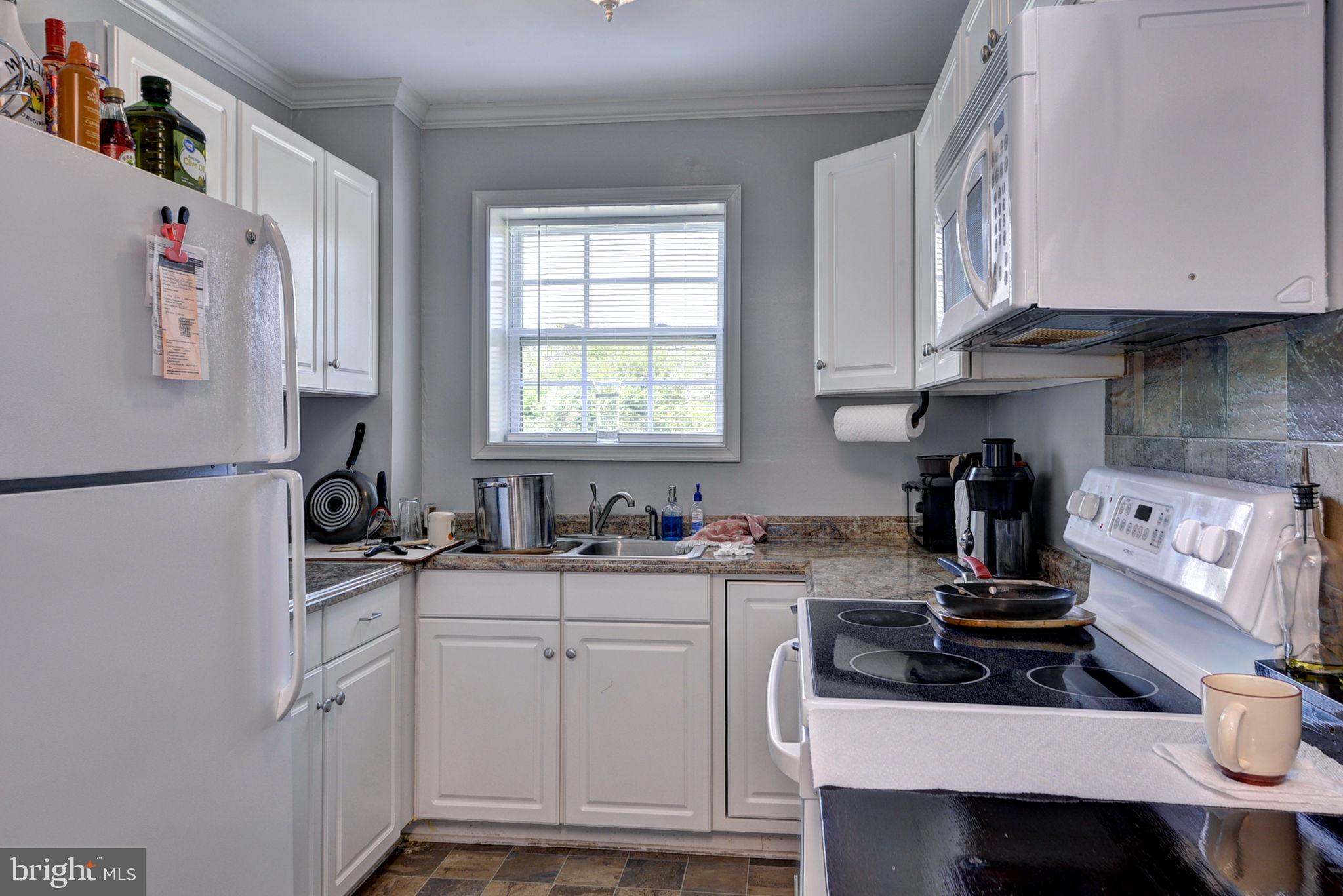 1025 Goodluck Road Lancaster, VA 22503 - Photo 126 of 132 a kitchen with stainless steel appliances granite countertop a sink stove and refrigerator