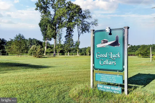 a view of a lake with a yard and outdoor seating