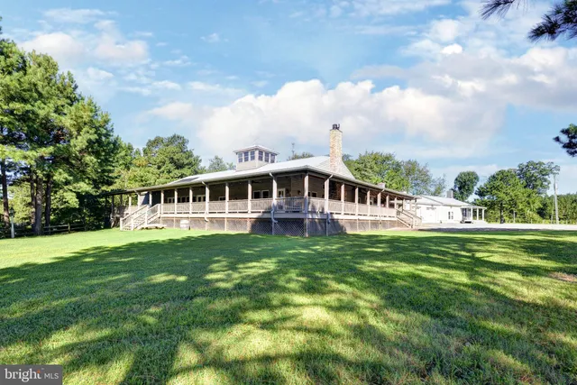 a table with wine bottles and glasses on it